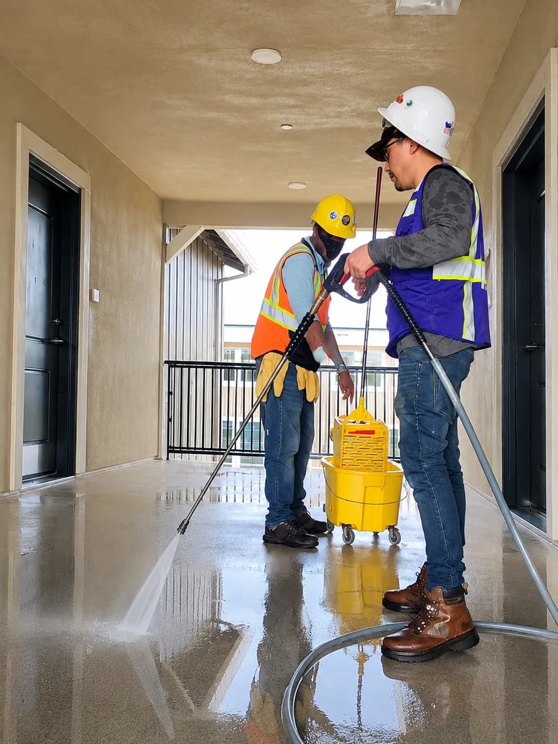 Complete JCCS crew soft-washing a commercial exterior surface on a Northern California job site