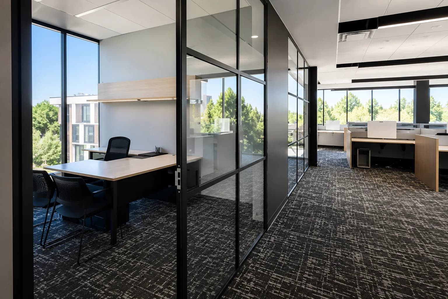 Modern corporate office interior with glass partitions cleaned by Complete JCCS